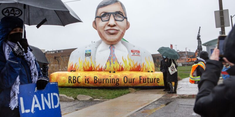15 foot inflatable of RBC CEO Dave McKay outside the AGM in the rain