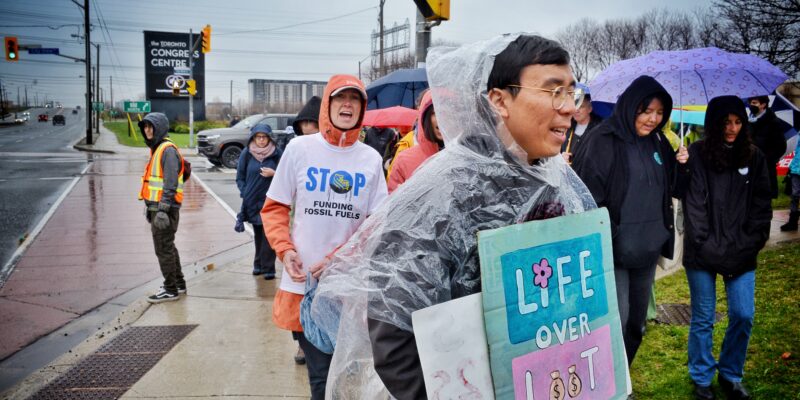 People march in the rain outside RBC's AGM