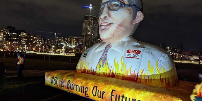 3 meter tall inflatable bust of RBC CEO Dave McKay with text reading "RBC is burning our future"