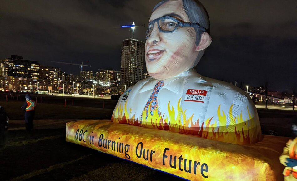3 meter tall inflatable bust of RBC CEO Dave McKay with text reading "RBC is burning our future"